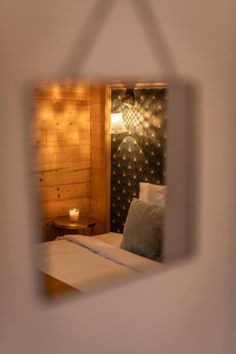 a view of a bedroom with a bed and a candle at chalet 1 - les jolis chalets in Barbey-Séroux