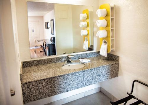 a bathroom with a sink and a mirror at Motel 6-Corsicana, TX in Corsicana