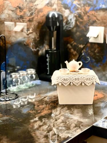 a table with a tea pot on top of it at Μάζης Εξοχικές Κατοικίες in Dhiyeliótika