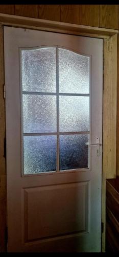 a door with a window in a room at Bungu Bangu in Ventspils