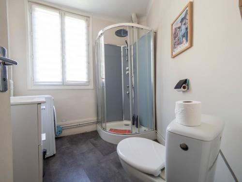 a bathroom with a shower and a toilet and a sink at La Chaussee in Bernay