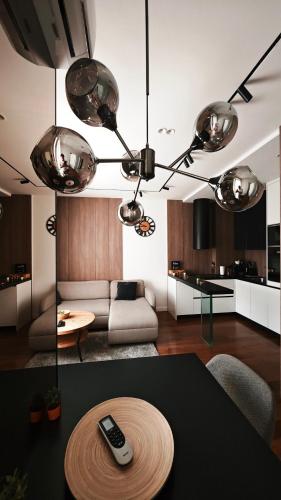 a living room with a remote control on a table at ModernApartmentsBL in Banja Luka