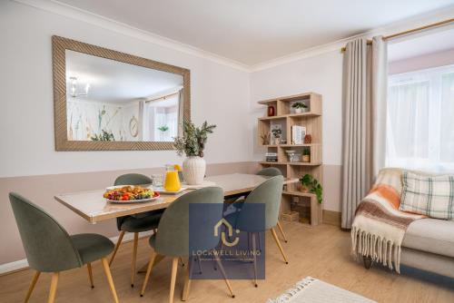 a living room with a table and chairs and a bedroom at Chalfont Haven in Latimer