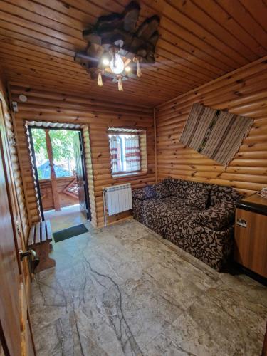 a room with a bed in a log cabin at Гуцульська хата in Yaremche