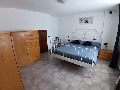 a bedroom with a bed and a dresser at Nonna Lidie in Aymavilles
