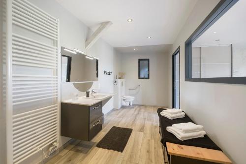 a bathroom with a sink and a toilet at Gite Du Bois in Ponts