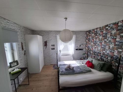a bedroom with a bed and a brick wall at Bieber`s Gästezimmer in Lilla Norge