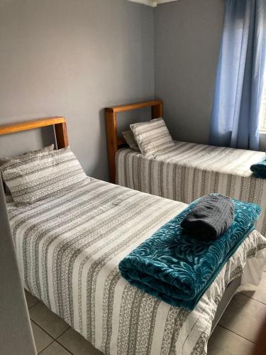 two twin beds in a room with at Tortilla no 3 in Bloemfontein