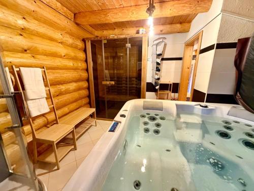 a bathroom with a jacuzzi tub in a room at Wellness Chalet Tatry in Vysoké Tatry