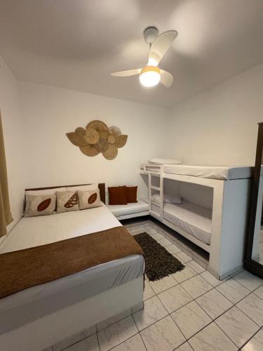 a bedroom with a bed and a ceiling fan at Apartamento Boqueirão Ilha Comprida Tati Ortega in Ilha Comprida
