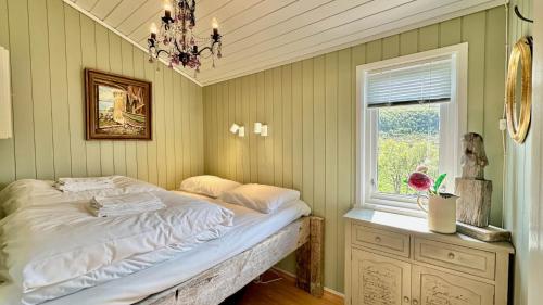 a bed in a room with a window and a bed sidx sidx sidx at Atlantic Shoreline Cabin in Vestvågøya
