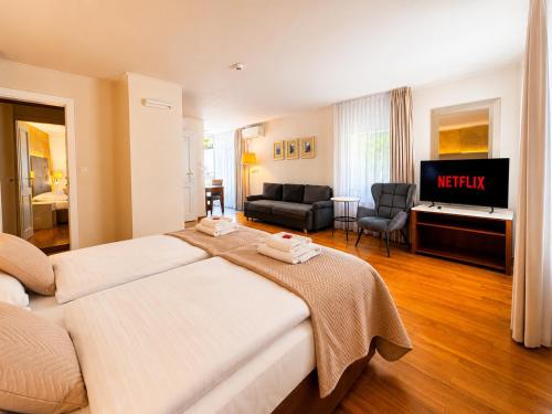 a hotel room with two beds and a television at LH Hotel Golden Wheel in Prague