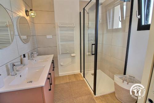 a bathroom with a sink and a shower at Enez bihan in Plougrescant