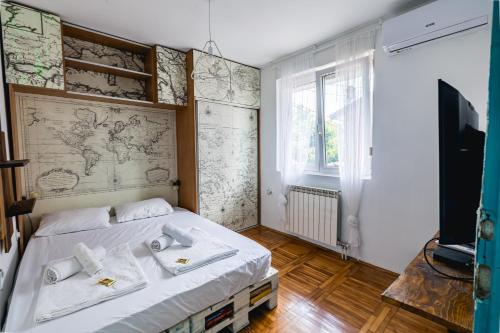 a bedroom with a bed with a map on the wall at Late Story in Podgorica