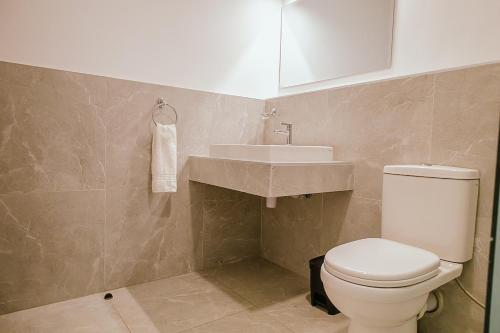 a bathroom with a toilet and a sink at Apartment in Tilisi in Gatimu