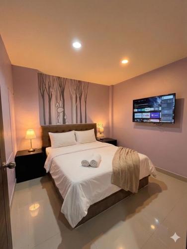 a bedroom with a bed with two towels on it at Rabbit Room in Bangkok
