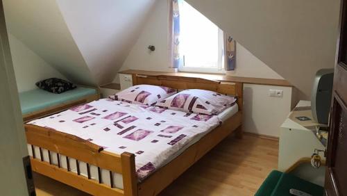 a bedroom with a wooden bed with a window at Chalupa Magdaléna in Terchová