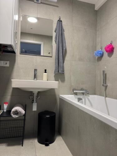 a bathroom with a sink and a bath tub at StayCentralcz- Loft in Opava