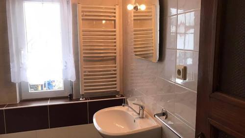 a bathroom with a sink and a window at Chalupa Magdaléna in Terchová