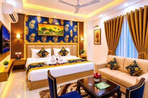 a hotel room with a bed and a couch at Hotel Decent Premier Suites Near Delhi Aerocity in New Delhi