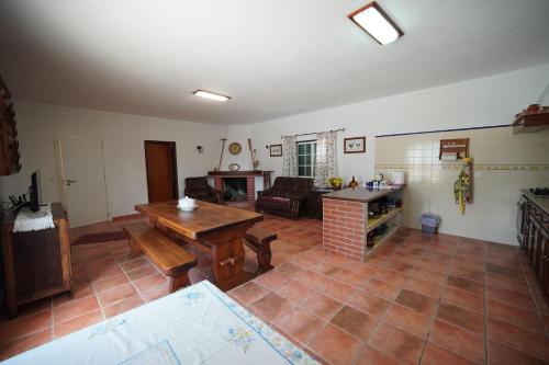 a large living room with a table and a couch at Casa de campo em Riachos in Riachos