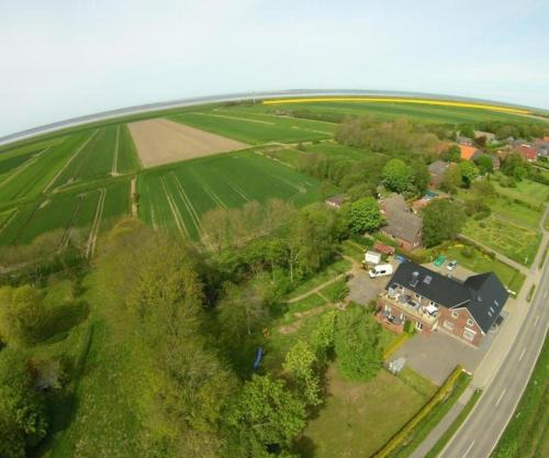 an aerial view of a house and a field at Ferienappartment Lhasa Apso in Dornum