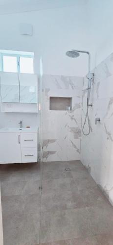 a bathroom with a shower and a sink at Perth property - Heritage Charm Meets Modern Ease close to all amenities including Midland Hospital in Midland Junction