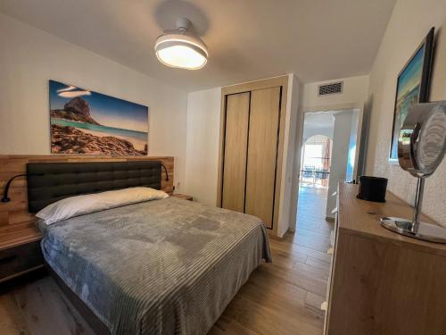 a bedroom with a bed and a television in it at Bungalows Imperial Park Unitursa in Calpe