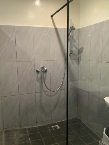 a shower with a glass door in a bathroom at Sarahlodge in Tahaa