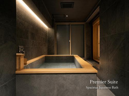 a bath room with a tub in a room at soyo-ka kyoto sanjo in Kyoto