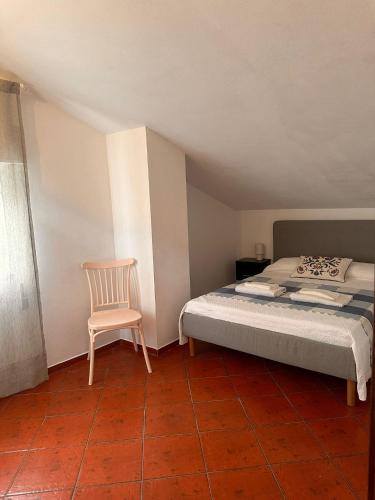 a bedroom with a bed and a chair at Lake House Gerês in Admeus