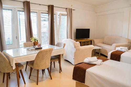 a room with a living room with a table and a couch at Kalinovi Apartments in Gevgelija