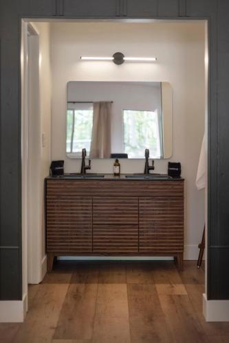 a bathroom with two sinks and a large mirror at The Warren Hotel in Bridgman