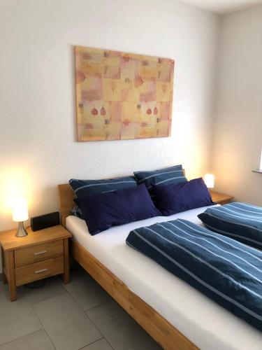a bedroom with two beds with blue pillows at Ferienwohnung Mosel in Piesport