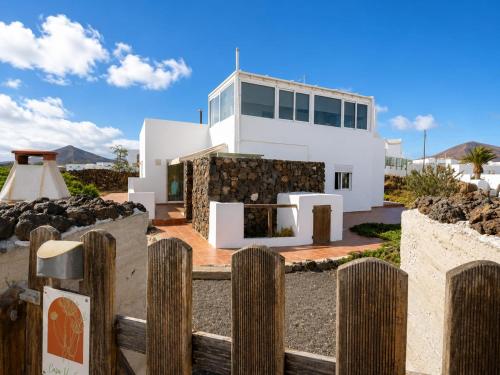 a house on the beach with a fence at Casa VEROLES in Tías