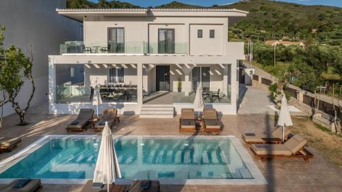 an aerial view of a villa with a swimming pool at Villa V - Infinity Holiday Villas, For Large Groups With Private Pool, by ZanteWize in Kalamaki