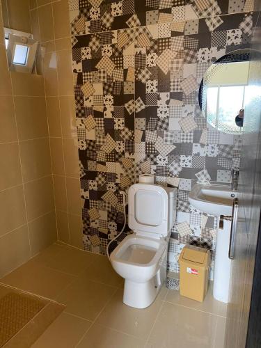 a bathroom with a toilet and a sink at Chalet 102 - Zresidence - Faitroun in Al ‘Aqabah