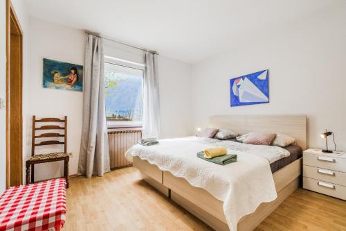 a bedroom with a bed and a window at Apartma Jager in Bovec