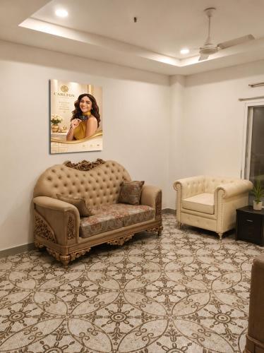 a living room with a couch and a chair at Hotel Granton By Carlton Suites in Hyderabad
