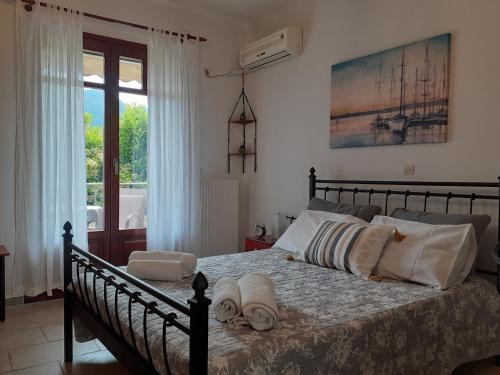 a bedroom with a bed with towels on it at Vagionia Apartments in Ancient Epidauros