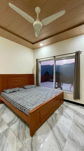 a bedroom with a bed and a large window at 2 Bed Apartment With View in Patriata