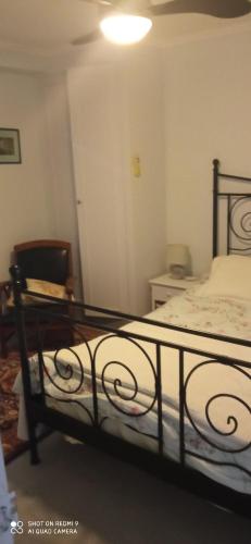 a bedroom with a bed and a chair at Les Ouilerres in Mervent
