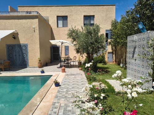 a house with a swimming pool in the yard at Dar Zaytouna in Oulad Akkou