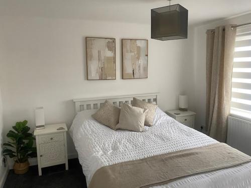 a bedroom with a bed with two night stands and two lamps at Harbour Point Apartment in Saltcoats