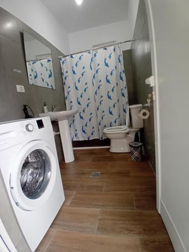 a bathroom with a washing machine and a toilet at Panorama Palace 2 in Palasë