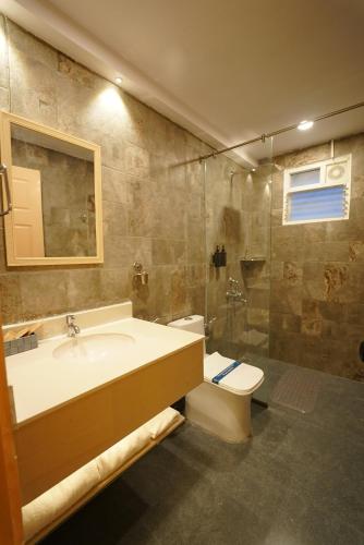 a bathroom with a sink and a toilet and a shower at Anaasa Resorts in Tiruvannāmalai