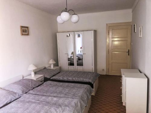 a bedroom with two beds and a mirror at Villa Forestside Villa by Interhome in Planá nad Lužnicí