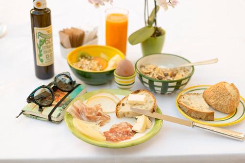 a table with a plate of food with bread and other foods at Relais Regina Giovanna in Sorrento
