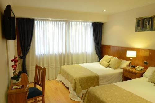 Postel nebo postele na pokoji v ubytování Ñikén Hotel & Spa