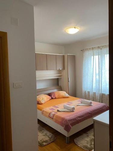 a bedroom with a bed with two towels on it at H&T in Senj